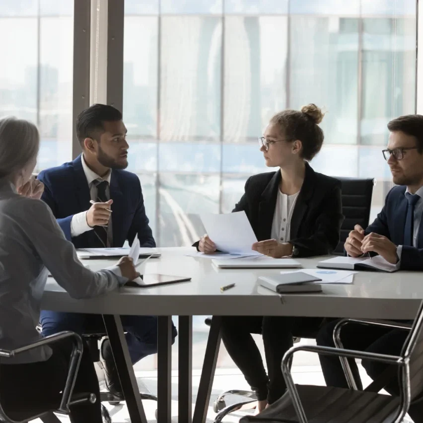 Business meeting with four professionals discussing.